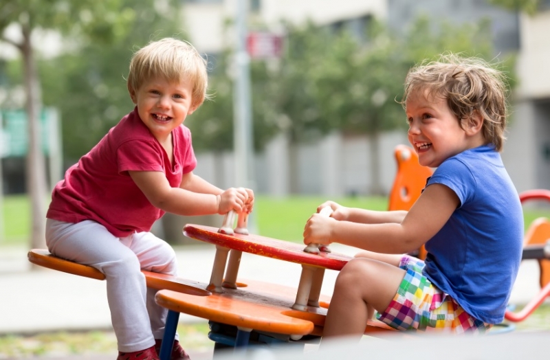 The children played in the garden.   (happily)