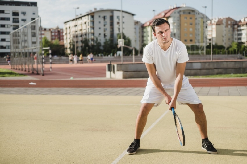 Young man playing tennis.