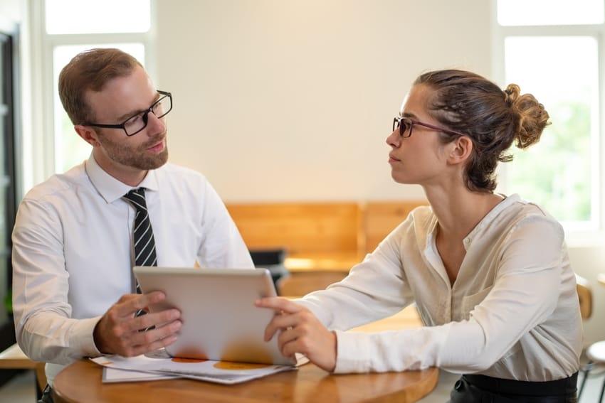 Business people working on table with tablet