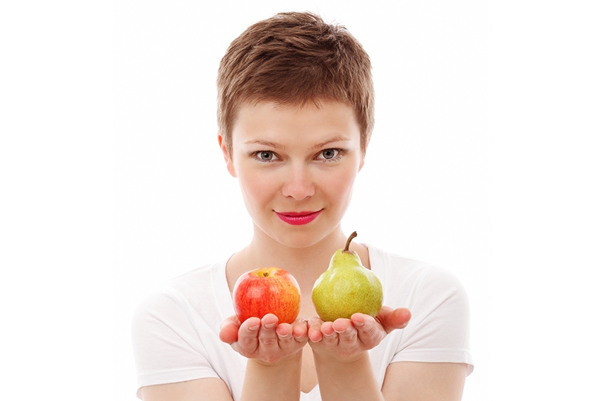 Woman holding an apple and a pear